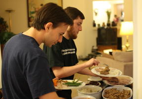 Alex and Mike Serving Dinner