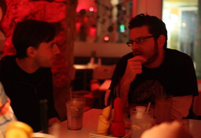 Alex and Petros Talking at Dinner